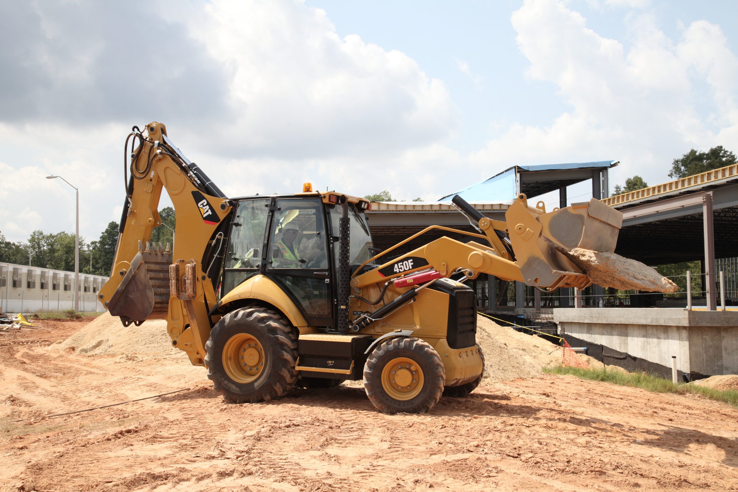 Backhoe Loader picking up a piece of stone
