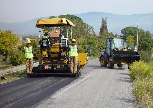 asphalt paver being used on the road