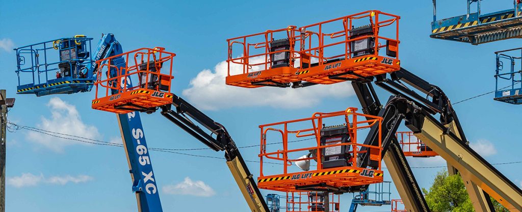 orange and blue manlifts with a blue sky background